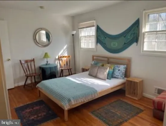 a bedroom with a bed a table and chair