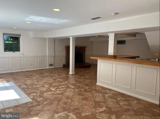 a view of kitchen with stainless steel appliances granite countertop a stove and a sink