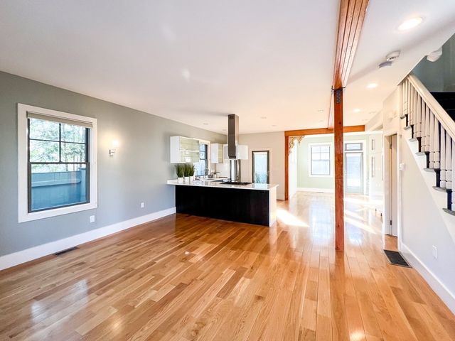 a view of kitchen and hall with wooden floor