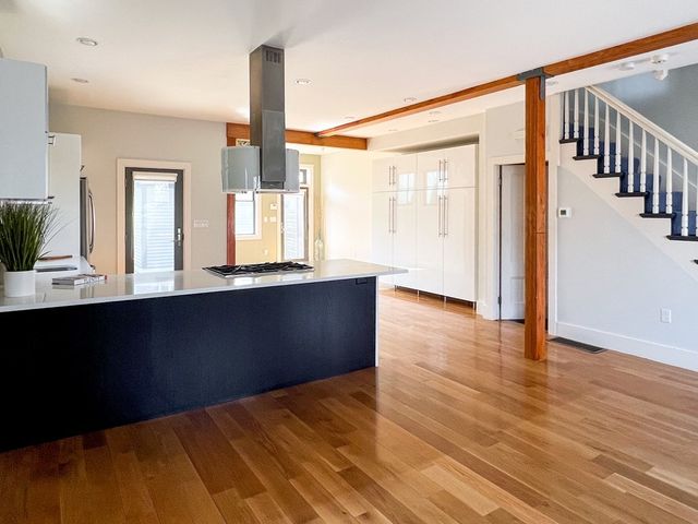 a view of a room with wooden floor and windows