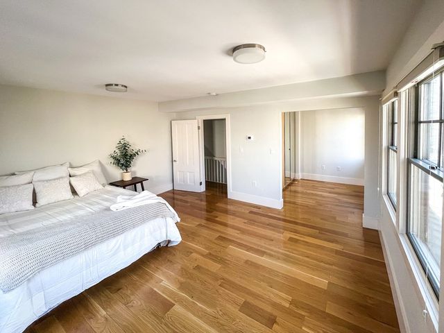 a spacious bedroom with a bed and a large mirror