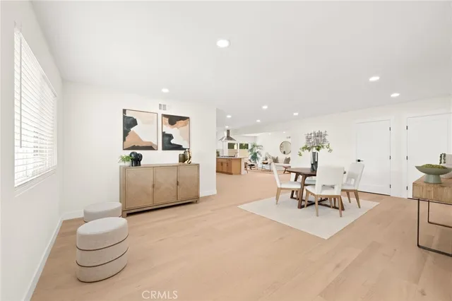 a living room with furniture a rug and a window