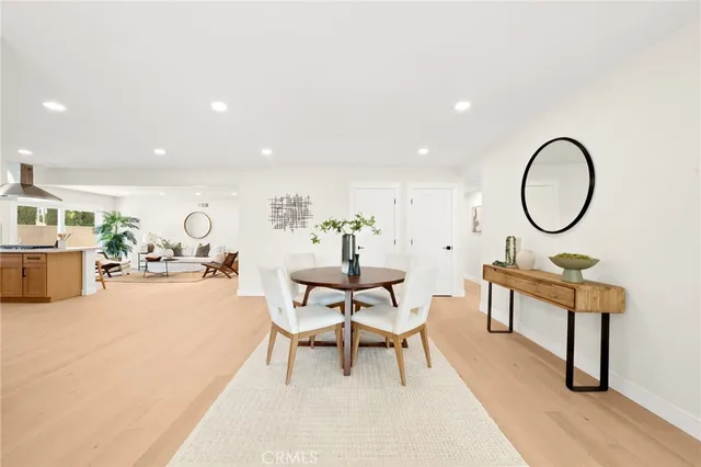 a large white kitchen with stainless steel appliances