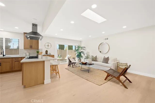 a kitchen with stainless steel appliances granite countertop a sink a stove and a refrigerator