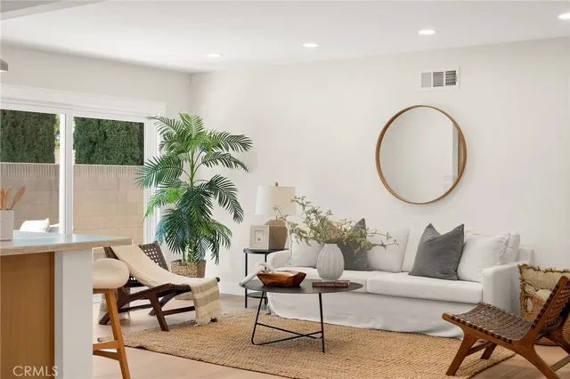 a living room with furniture a rug and white walls
