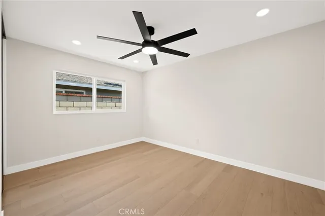 a view of a backyard with white wall