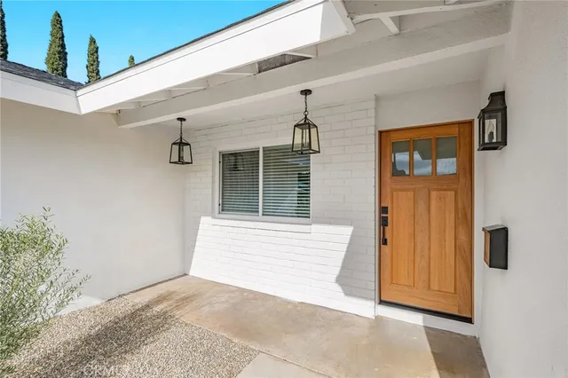 a living room with furniture a fireplace and a large window