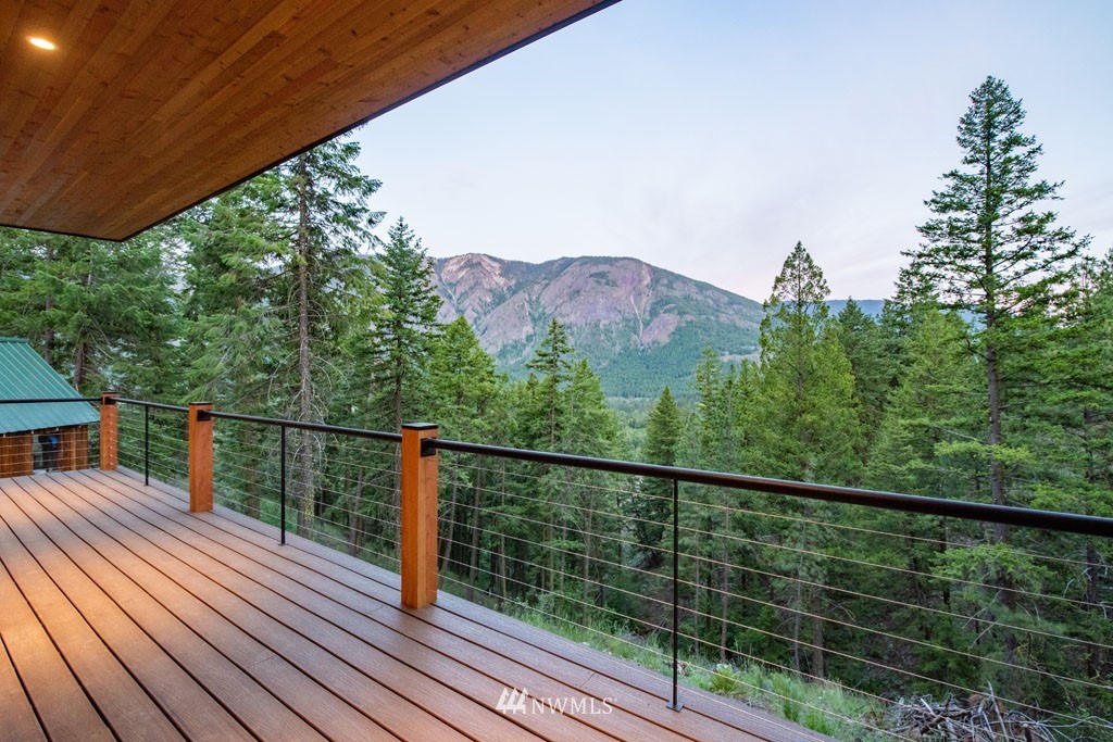 39 Bitterbrush Road Winthrop, WA 98862 - Photo 14 of 40 a view of a balcony with wooden floor and fence