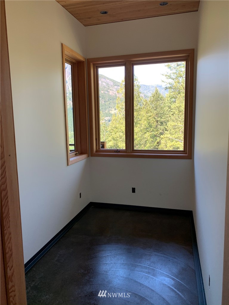 39 Bitterbrush Road Winthrop, WA 98862 - Photo 19 of 40 an empty room with wooden floor and a window