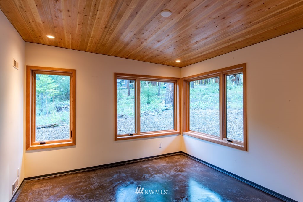 39 Bitterbrush Road Winthrop, WA 98862 - Photo 24 of 40 an empty room with wooden floor and windows