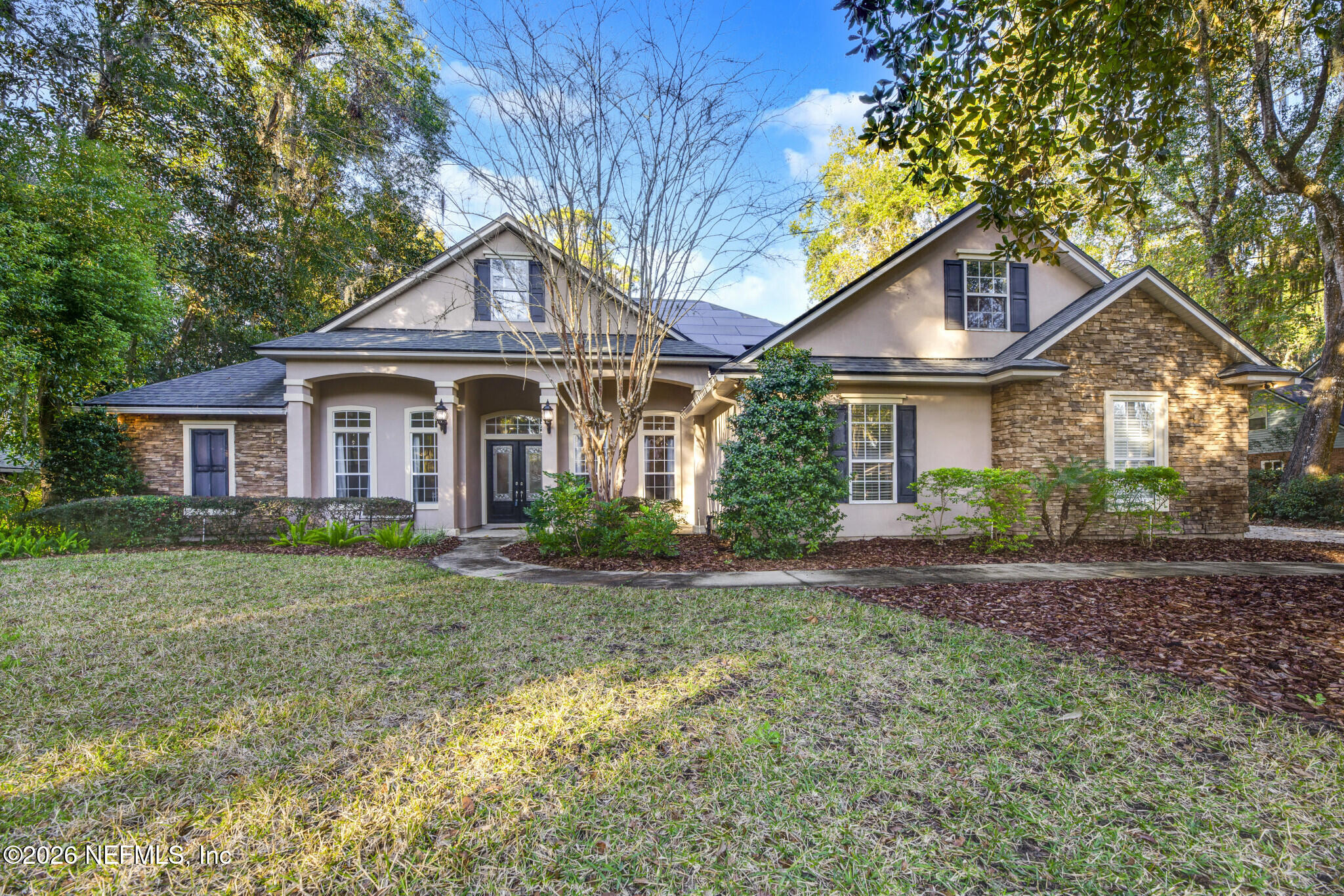 1478 Kathleen Way Fleming Island, FL 32003 - Photo 2 of 35 a front view of a house with a yard and trees