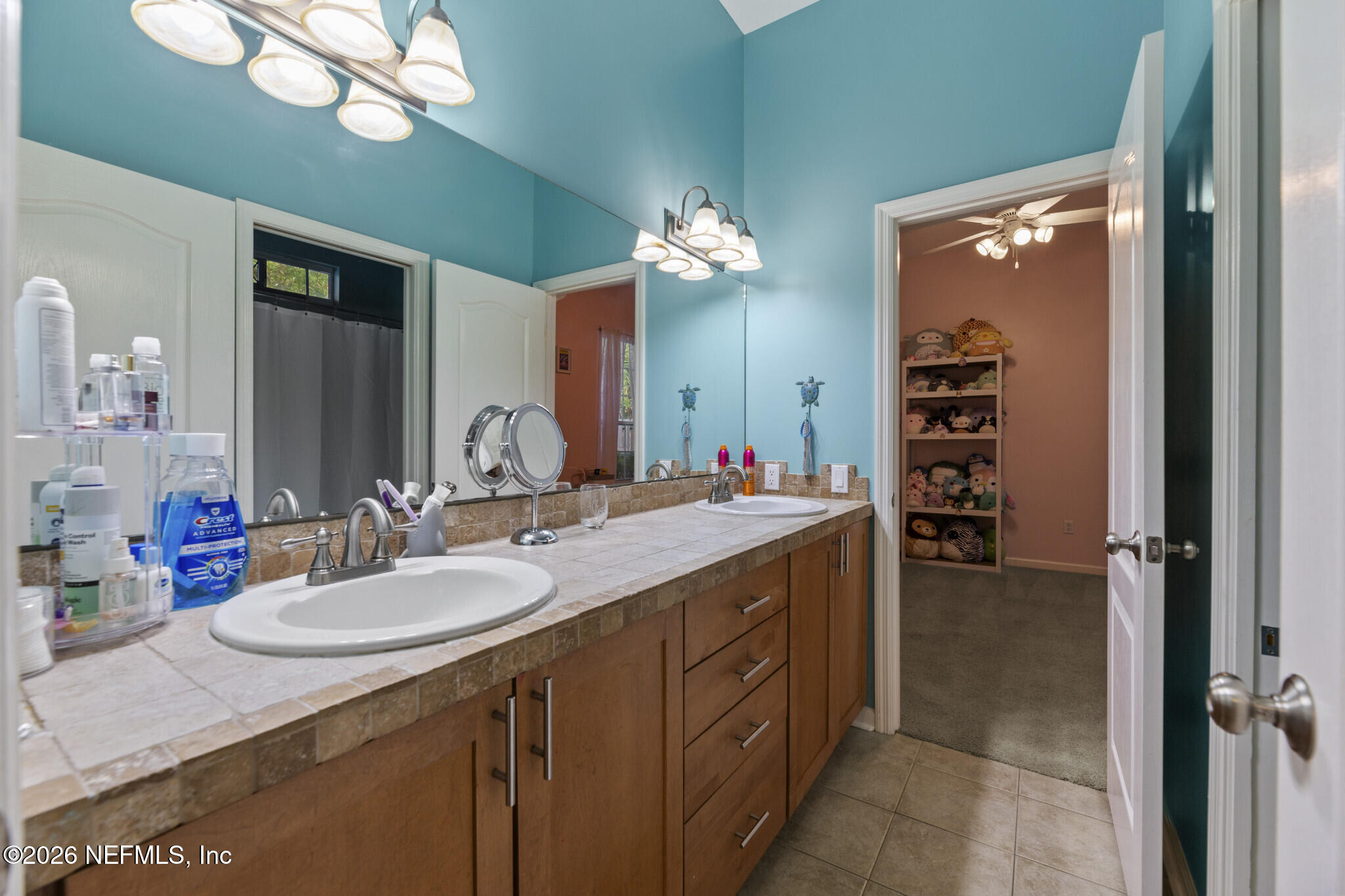 1478 Kathleen Way Fleming Island, FL 32003 - Photo 24 of 35 a bathroom with a sink double vanity and a mirror