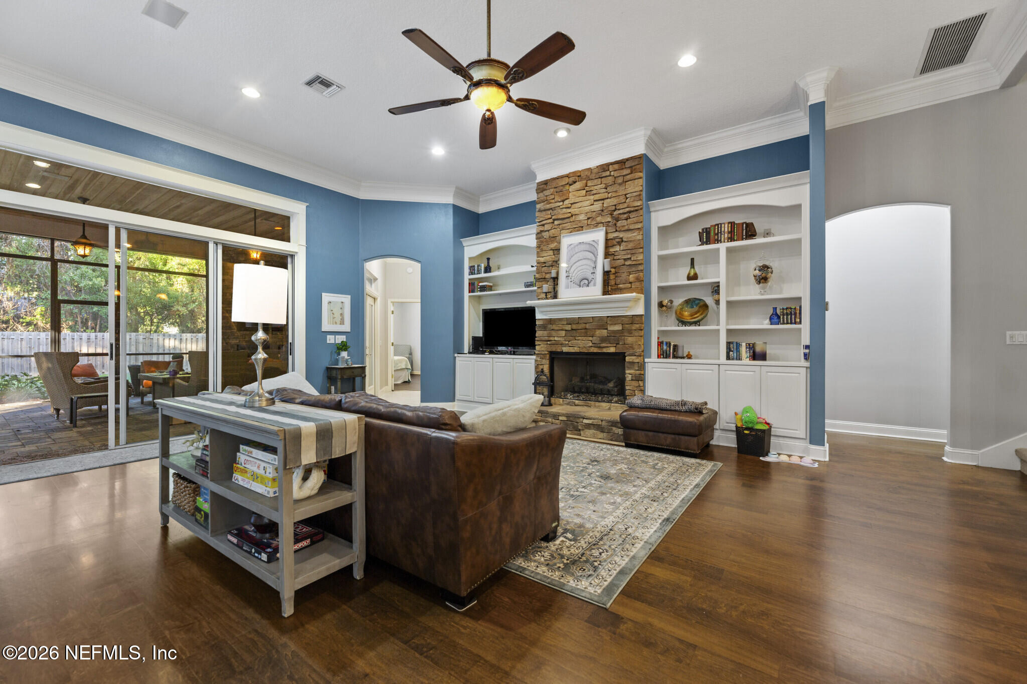 1478 Kathleen Way Fleming Island, FL 32003 - Photo 7 of 35 a living room with furniture a fireplace and a large window