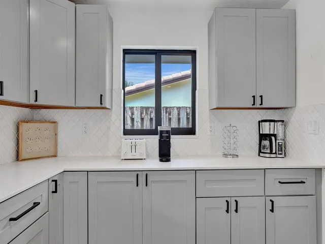 a kitchen with cabinets and window