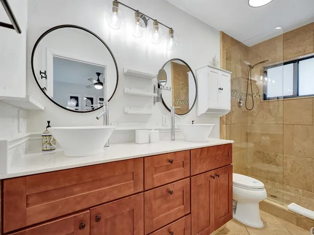 a bathroom with a toilet a sink and a mirror