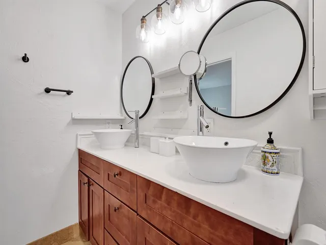 a bedroom with a bed and painting on the wall