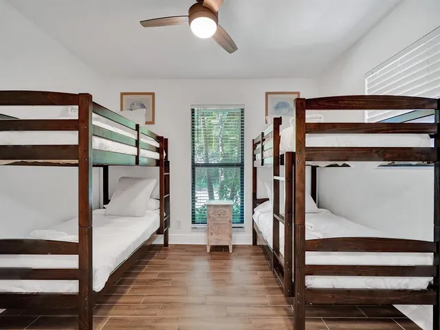 a bathroom with a sink a toilet a mirror and shower