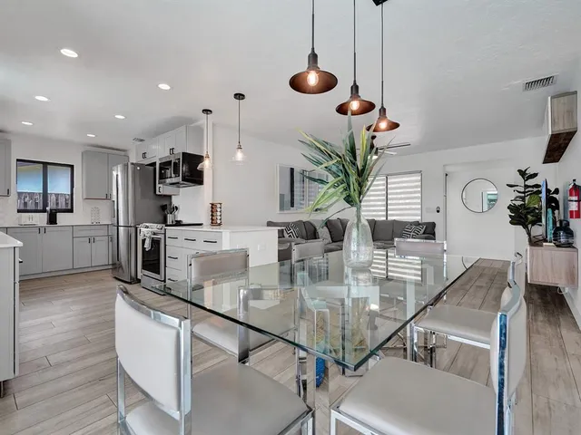 a backyard of a house with barbeque oven table and chairs