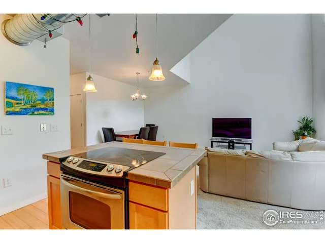 a kitchen with a stove a refrigerator and a dining table