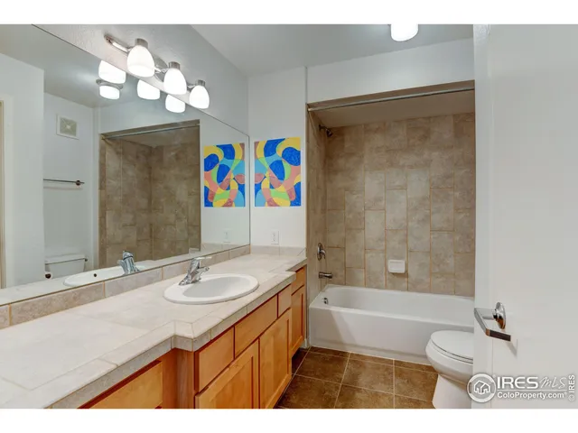 a bathroom with a sink a toilet a shower curtain and a mirror