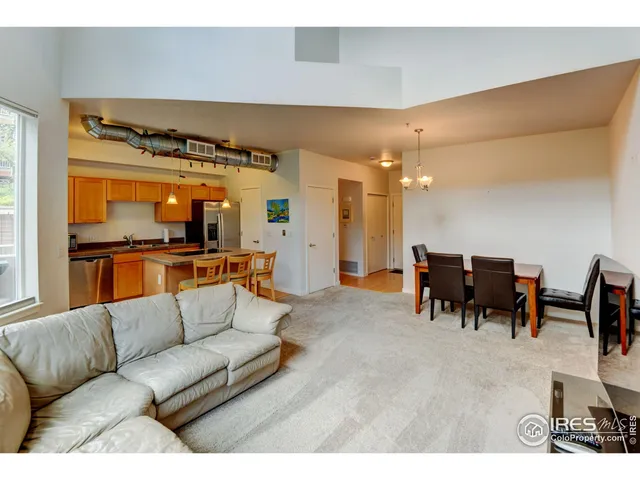a living room with furniture and a dining table