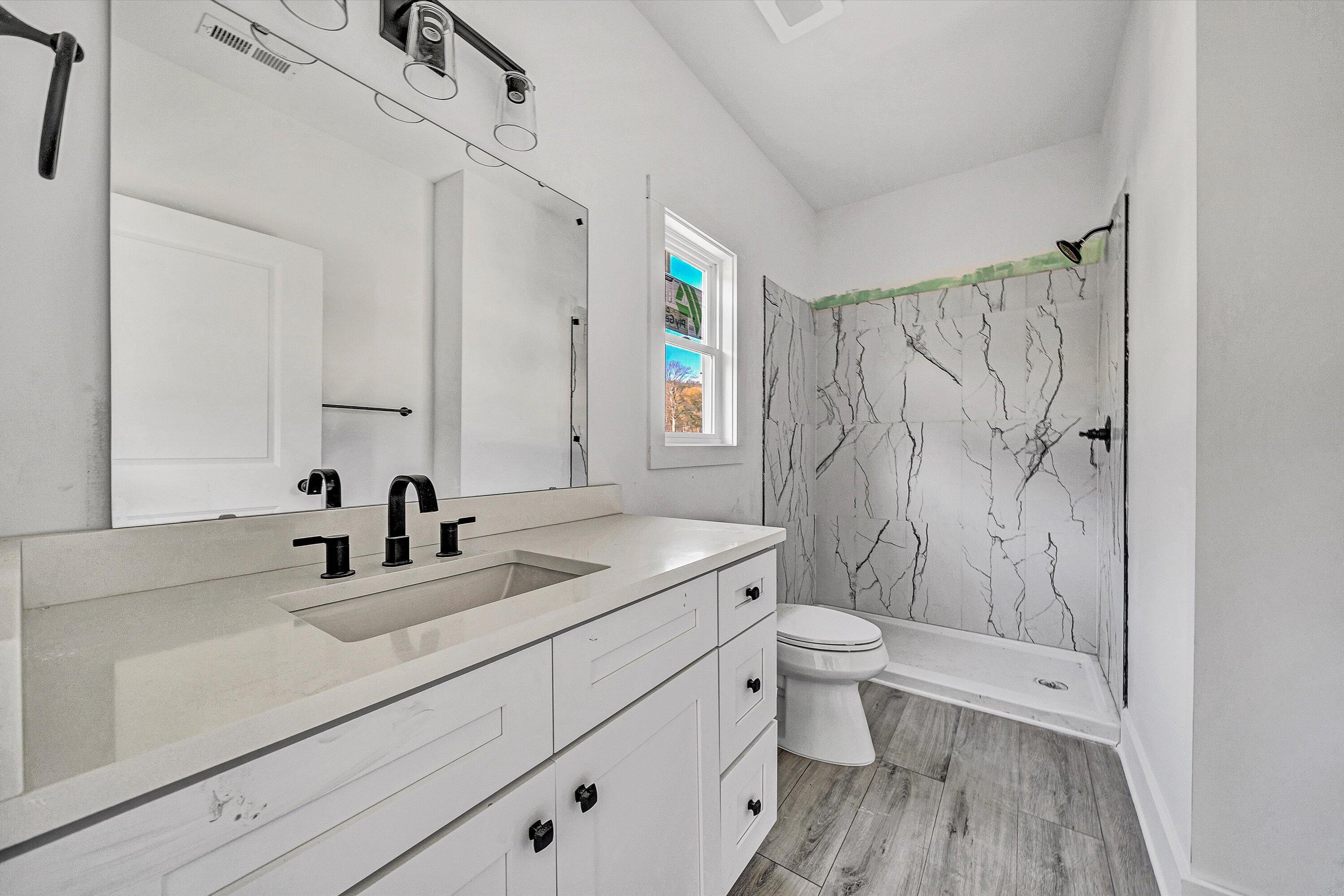 3086 Haymakertown Road Troutville, VA 24175 - Photo 13 of 16 a bathroom with a sink a toilet and a mirror