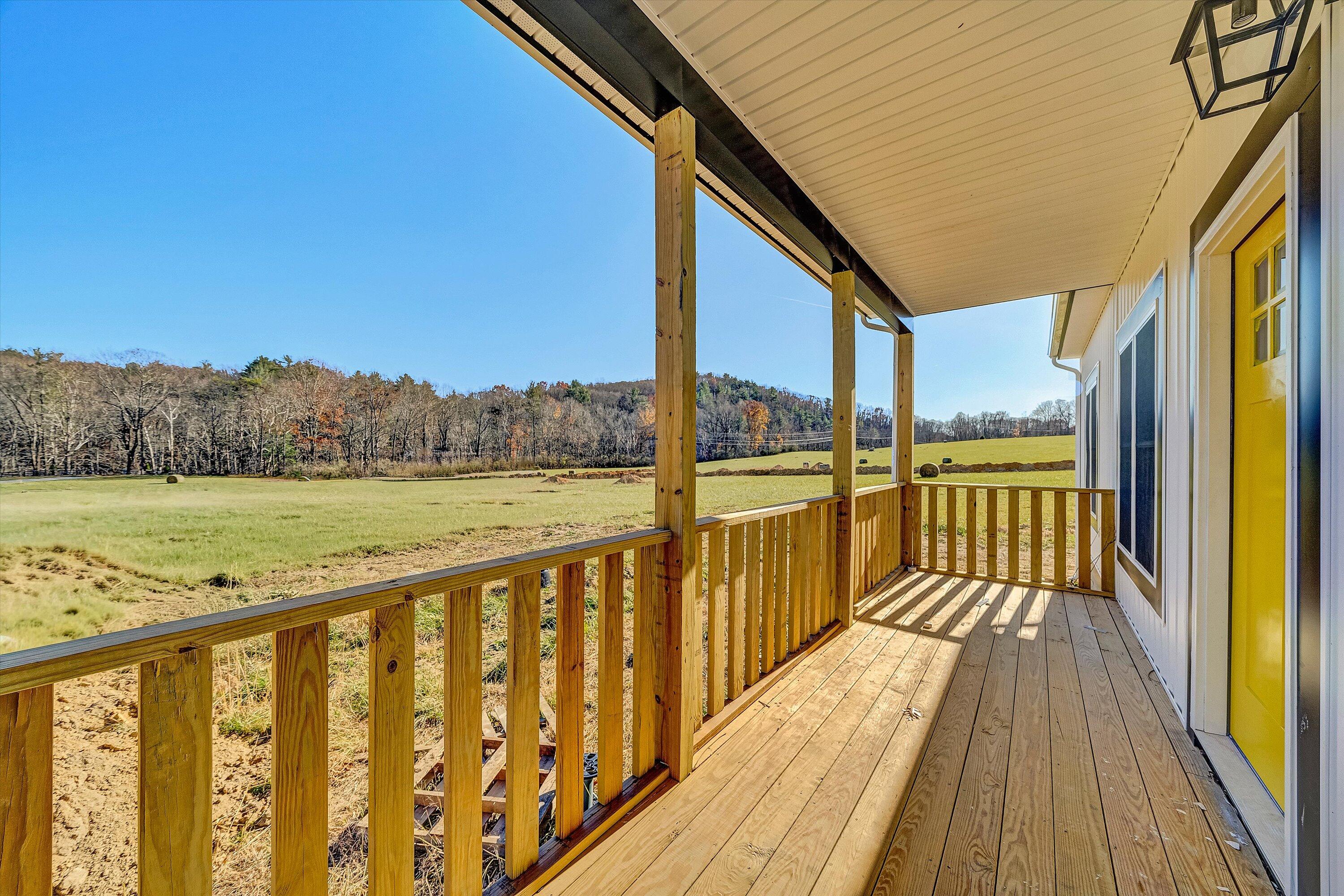 3086 Haymakertown Road Troutville, VA 24175 - Photo 2 of 16 a view of a balcony with wooden floor & fence