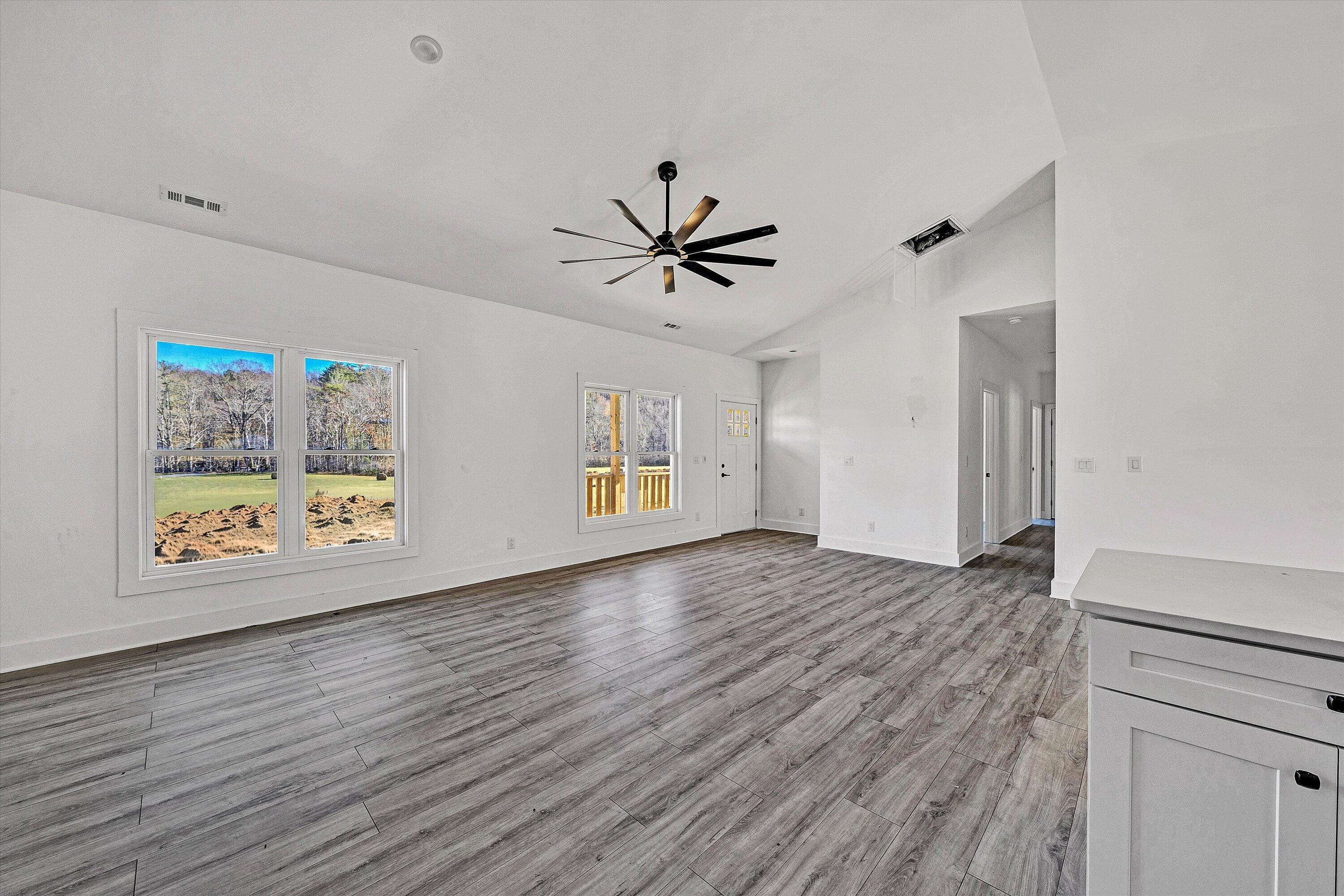 3086 Haymakertown Road Troutville, VA 24175 - Photo 3 of 16 a view of an empty room with window and wooden floor