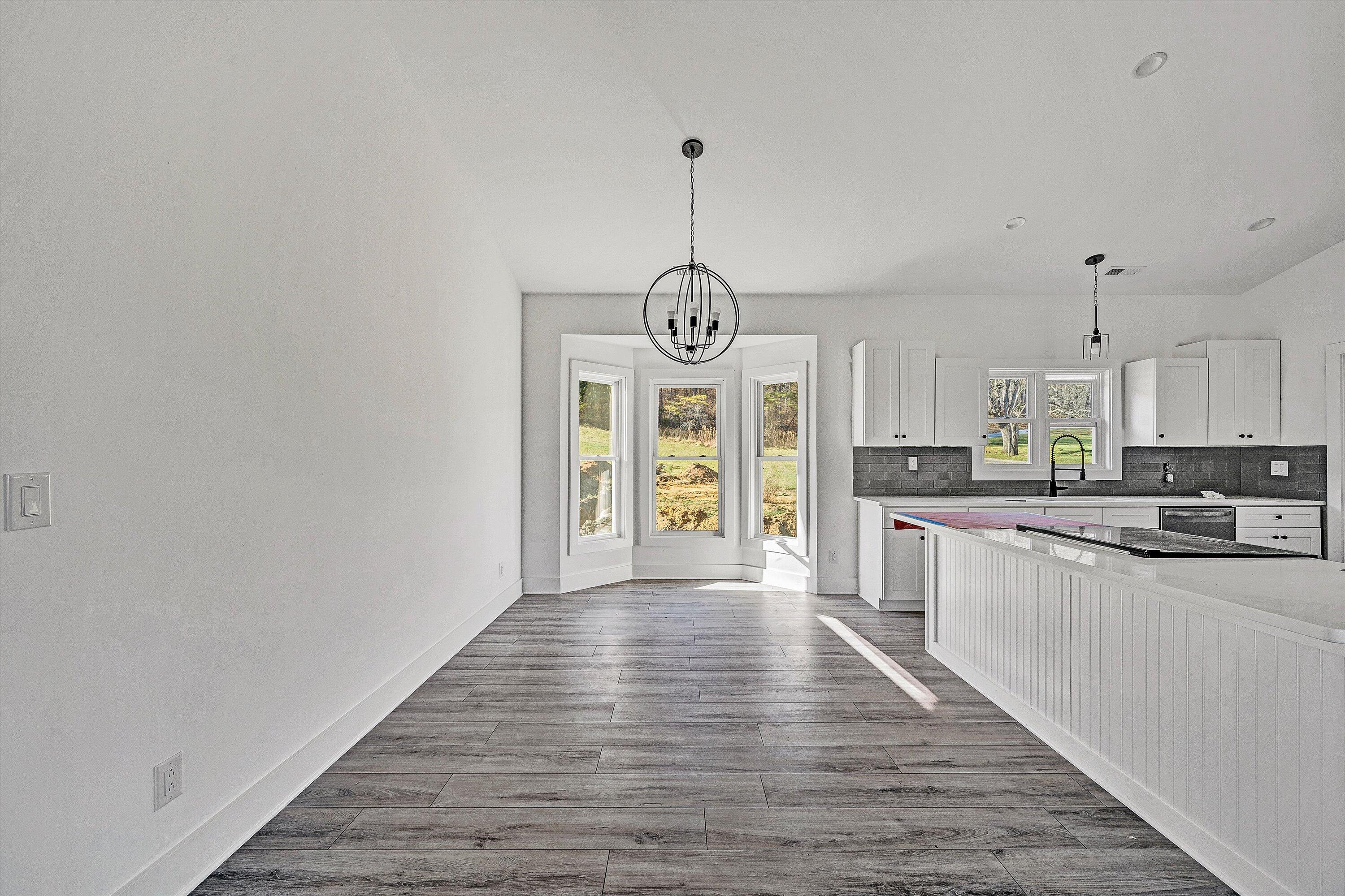 3086 Haymakertown Road Troutville, VA 24175 - Photo 6 of 16 a large kitchen with granite countertop a stove top oven a sink dishwasher and a refrigerator with wooden floor