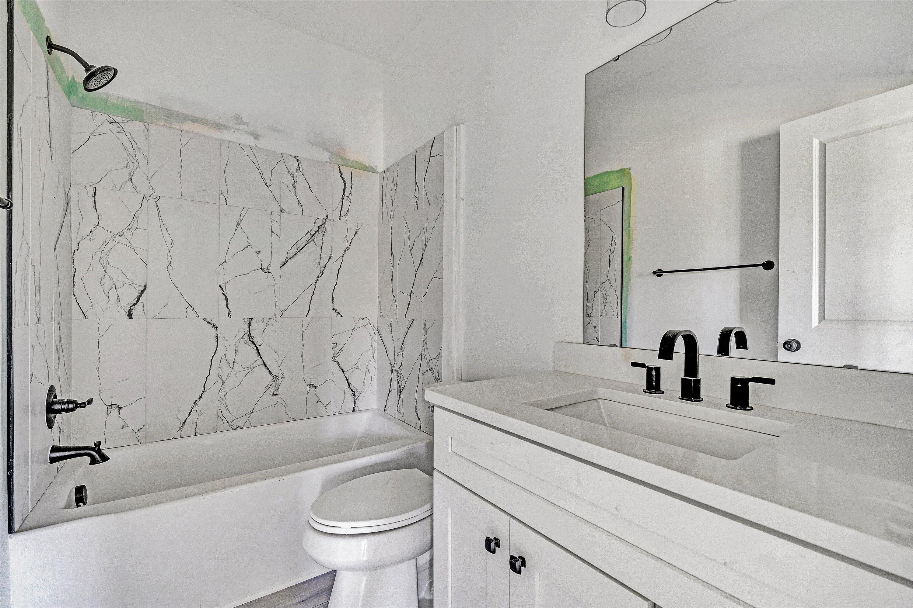 3086 Haymakertown Road Troutville, VA 24175 - Photo 10 of 16 a bathroom with a granite countertop sink a toilet and a bathtub