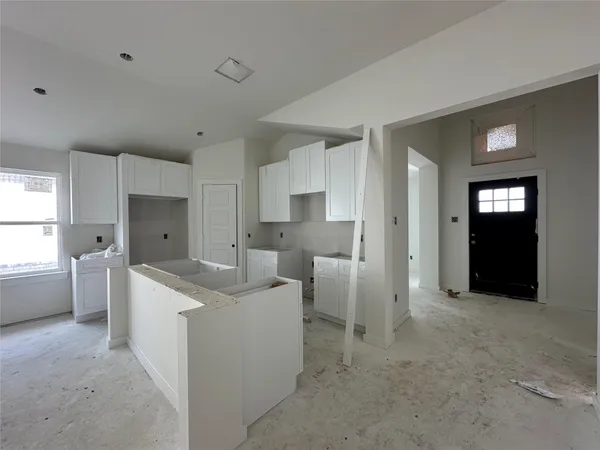 a kitchen that has a sink and a stove in it