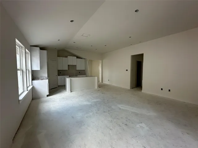 a view of a livingroom with kitchen and furniture