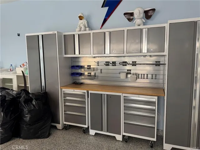 a kitchen with stainless steel appliances granite countertop a refrigerator and a stove