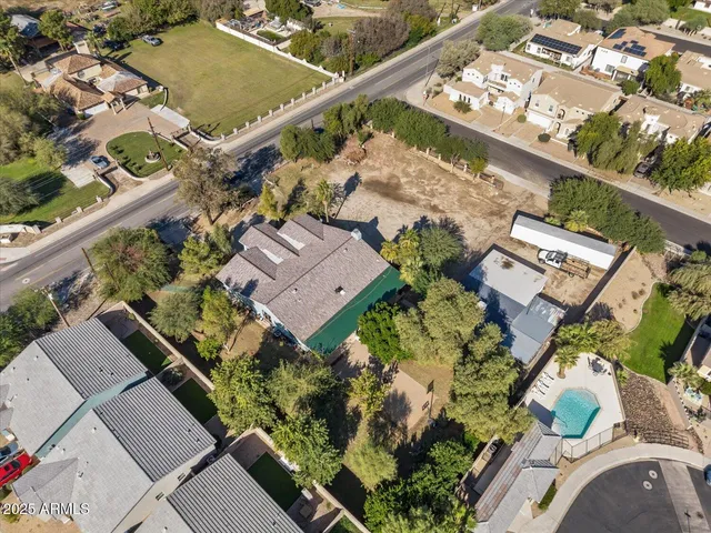 a large bed sitting in a bedroom next to a window