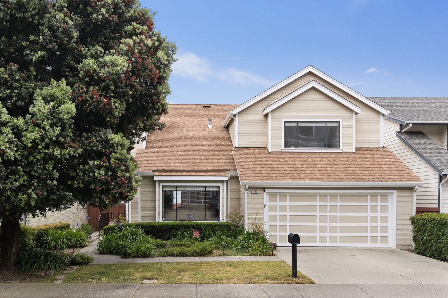 a front view of a house with garage