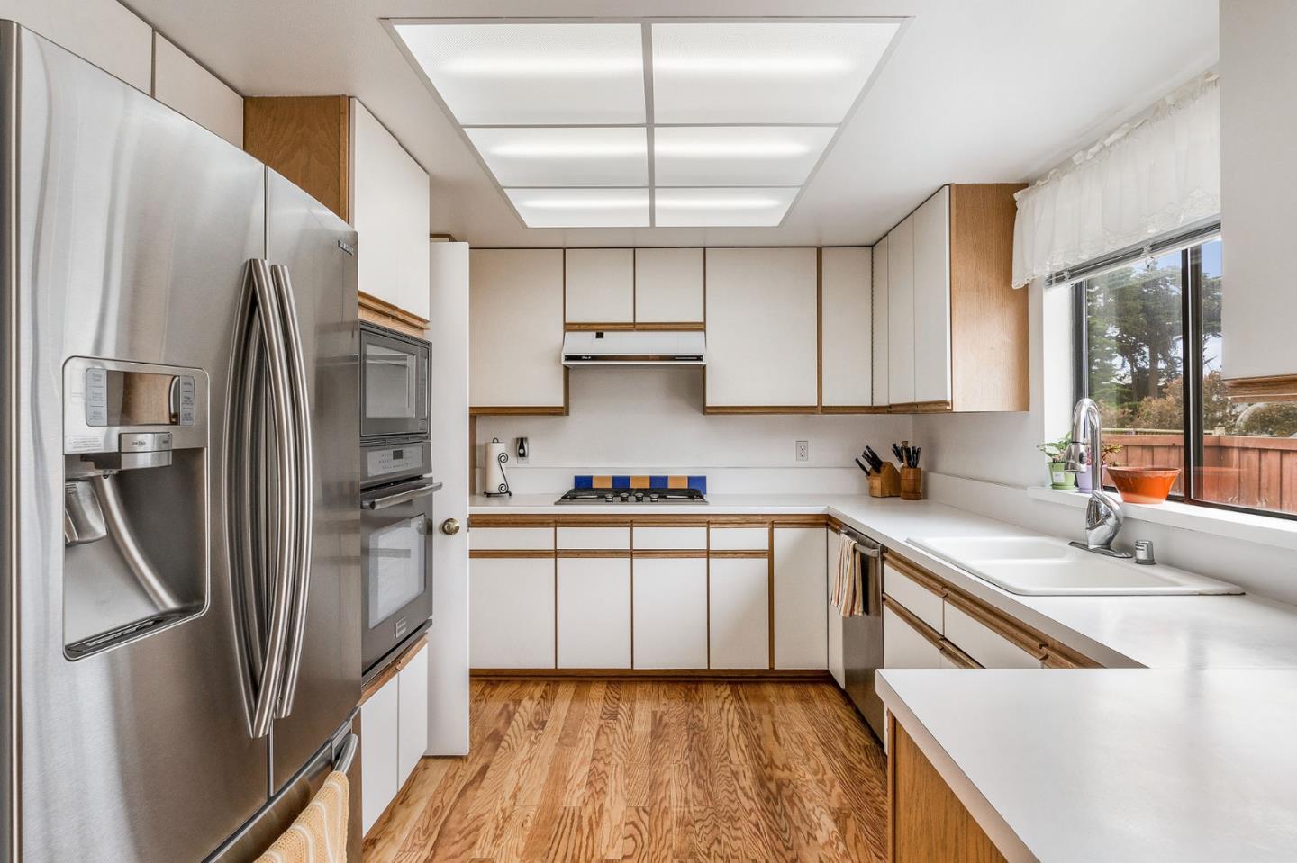 360 Winwood Avenue Pacifica, CA 94044 - Photo 13 of 26 a kitchen with stainless steel appliances a refrigerator sink and cabinets