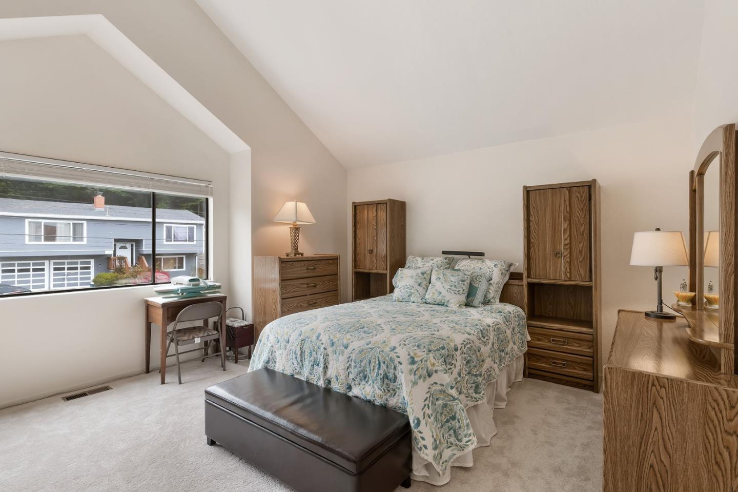 360 Winwood Avenue Pacifica, CA 94044 - Photo 19 of 26 a room with a bed and large windows