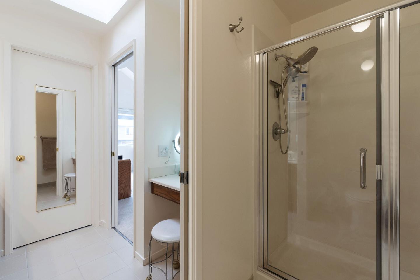 360 Winwood Avenue Pacifica, CA 94044 - Photo 21 of 26 a bathroom with a glass shower door and a mirror