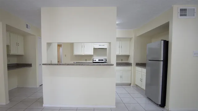a kitchen with a refrigerator and a sink