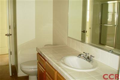 15 Chamiso Drive Los Alamos, CA 93440 - Photo 11 of 15 a bathroom with a sink toilet and shower