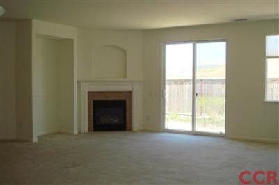 15 Chamiso Drive Los Alamos, CA 93440 - Photo 4 of 15 a view of an empty room with a fireplace and a window