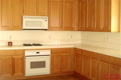 15 Chamiso Drive Los Alamos, CA 93440 - Photo 6 of 15 a kitchen with granite countertop cabinets stainless steel appliances a sink and dishwasher