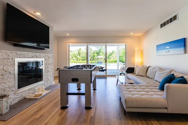 a living room with furniture a flat screen tv and a fireplace