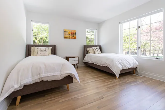 a bedroom with two beds and a window