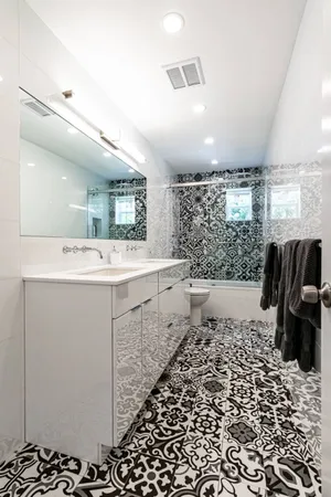 a bathroom with a sink a toilet and mirror