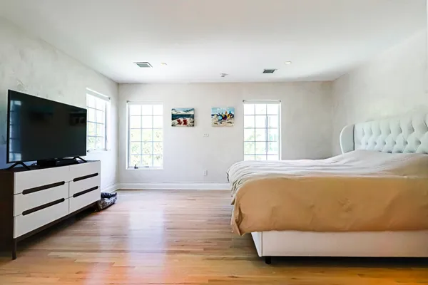 a bedroom with a bed and a flat screen tv