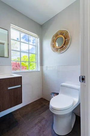 a bathroom with a toilet a sink and a window