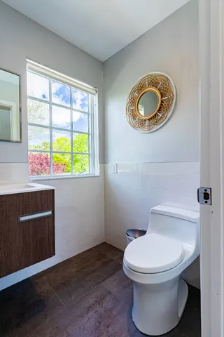 a bathroom with a toilet a sink and a window