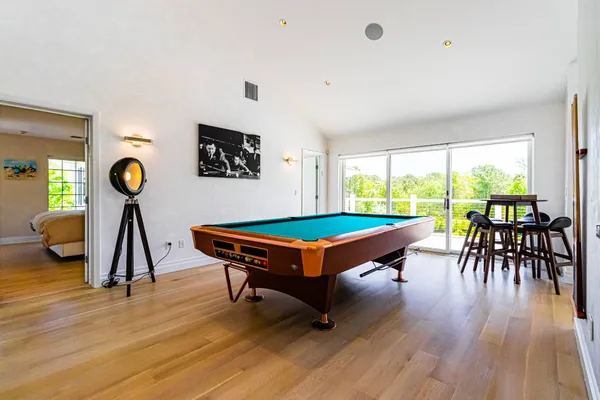 a room with furniture pool table and windows