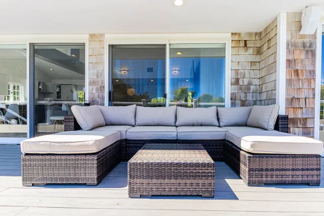 a living room with furniture a rug and a window